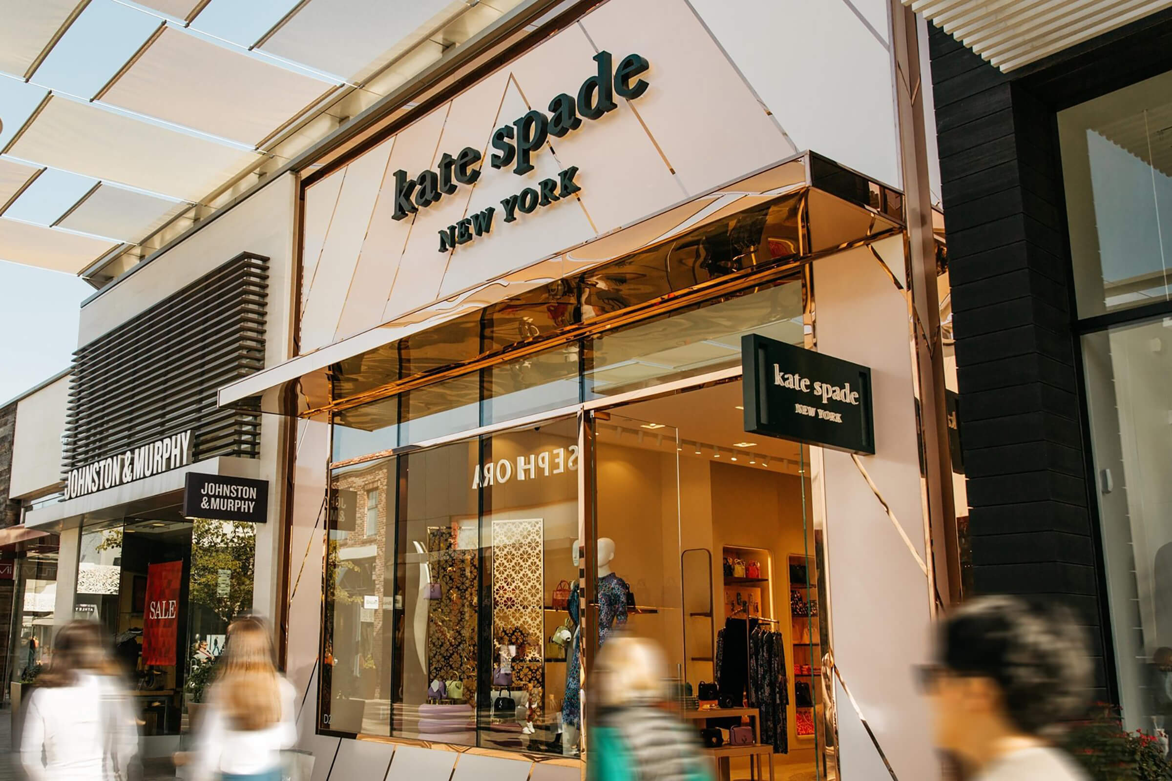 Canopy, window glazing bars and façade inset diagonal detailing in PVD coloured stainless steel Rose Gold Mirror.  
Kate Spade retail store, 4525 La Jolla Village Dr Suite D27, Westfield UTC, San Diego, California.
Designer: Rogers Partners
PVD: fabricated and supplied by Double Stone Steel in partnership with Kloeckner Metals Corporation
