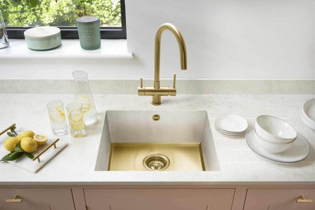 Sink by Caple in PVD coloured stainless steel in Gold Brush with matching waste, overflow and mixer tap.